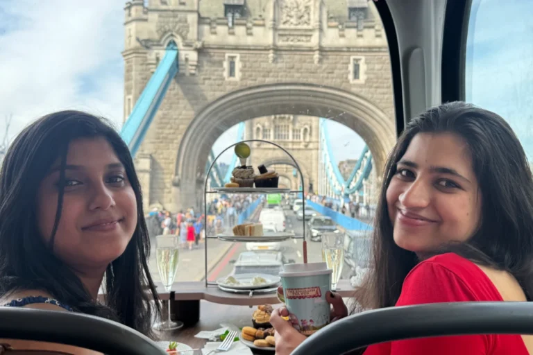 Golden Tours double-decker bus passing London landmarks during afternoon tea