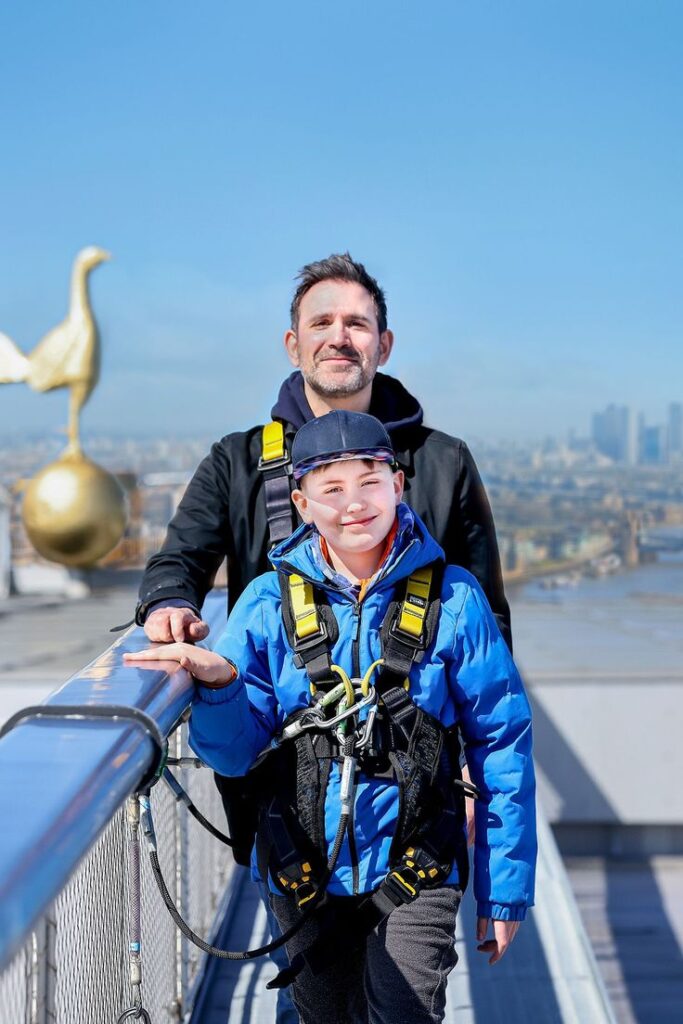 Father and son enjoying The Dare Skywalk at Tottenham Hotspur Stadium with London skyline views